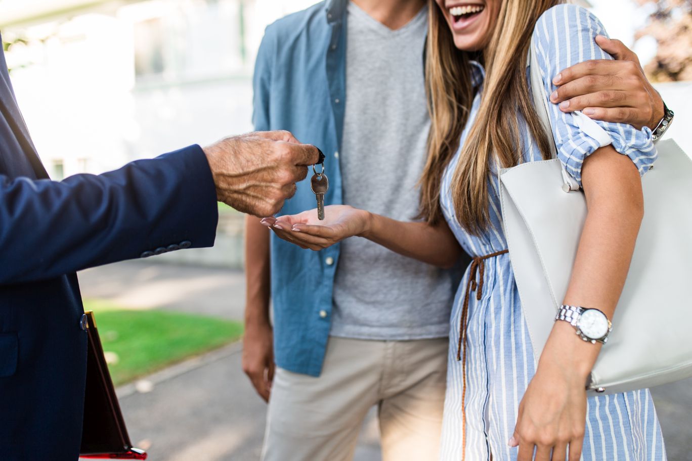 Real estate agent handing over key